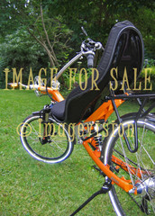 for sale orange recumbent bike on grass