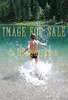 for sale child with water spatters in mountain lake