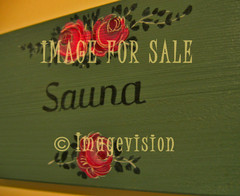 for sale sauna text and ornaments on green wood