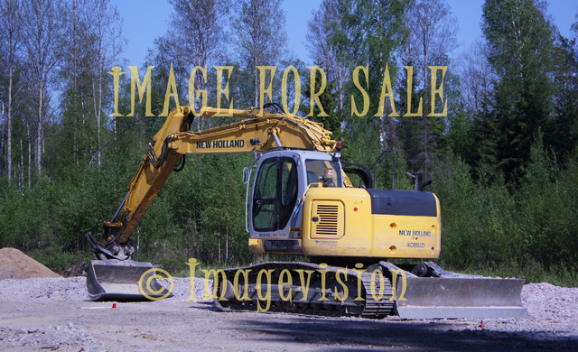 for sale yellow digger against forest